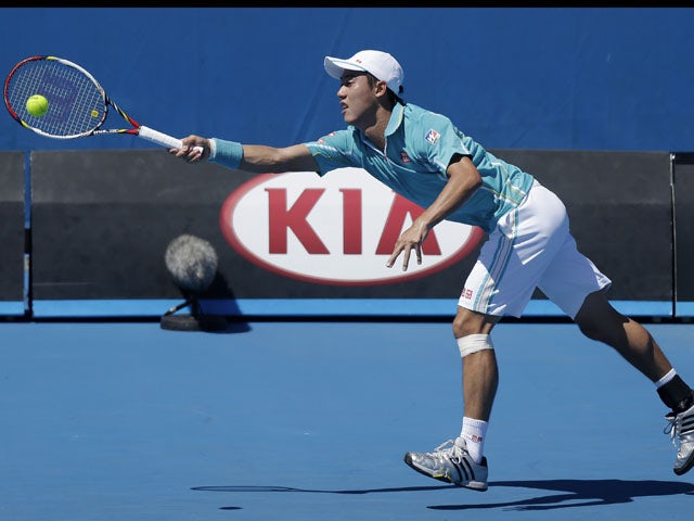 Kei Nishikori of Japan stretches for a shot during his second round match at the Australian Open tennis championship on January 16, 2013