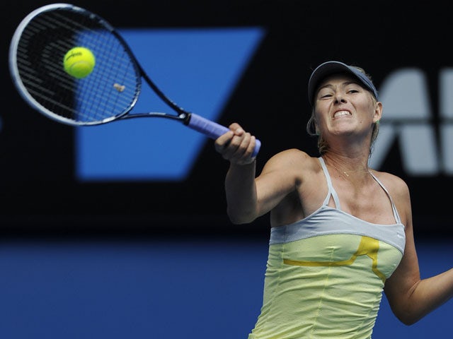 Russian Maria Sharapova returns a shot during her first round tie with Olga Puchkova during the Australian Open tennis championship on January 14, 2013