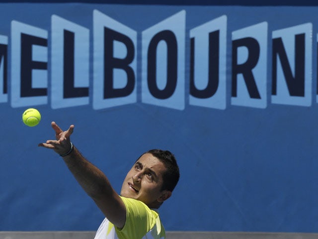 Spain's Nicolas Almagro serves to Steve Johnson in their first round match at the Australian Open tennis championship on January 14, 2013