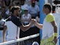 Serbia's Janko Tipsarevic and Nicolas Almagro shake hands after Tipsarevic retired injured in the fourth round of the Australian Open tennis championship on January 20, 2013