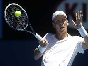 Tomas Berdych celebrates hits a return at the Australian Open tennis championship on January 16, 2013