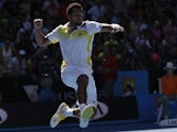 Jo-Wilfried Tsonga of France leaps in the air to celebrate his first round win over Michael Llodra  at the Australian Open tennis championship on January 15, 2013