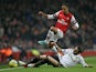 Chico Flores and Theo Walcott battle for the ball during the FA Cup third round replay on January 16, 2013
