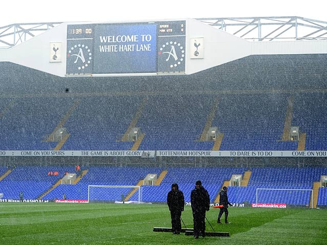 Groundstaff at White Hart Lane clear the snow from the pitch ahead of the match against Manchester United on January 20, 2013