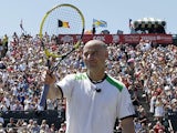 Former Tennis star Andre Agassi waves to the crowd during an exhibition match on July 10, 2011