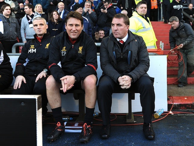 Liverpool boss Brendan Rodgers sits on the bench at Boundary Park before the game with Oldham on January 27, 2013