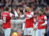 Arsenal player Oliver Giroud celebrates with his teammates after scoring the opening goal in his sides match with Brighton and Hove Albion on January 26, 2013