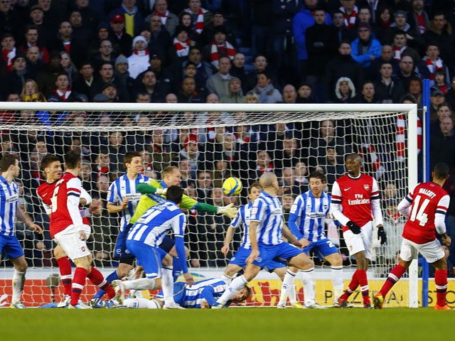 Arsenal's Theo Walcott scores his teams third goal in their FA Cup fourth round match on January 26, 2013