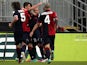 Cagliari players celebrates after Thiago Ribeiro scored a late equaliser against Palermo on January 27, 2013