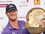 Chris Wood poses with the trophy after winning the Qatar Masters on January 26, 2013 