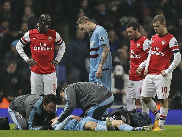Daniel Potts receives treatment on the pitch during the match against Arsenal on January 23, 2013