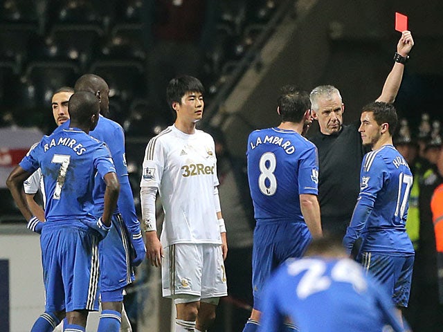 Eden Hazard is shown a red card for violent conduct after kicking a ball boy on January 23, 2013
