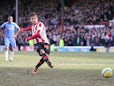 Brentford's Harry Forrester converts a penalty to score his team's second in the FA Cup fourth round tie with Chelsea on January 27, 2013