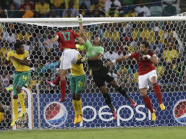 Morocco's Issam El Adoua heads a goal against South Africa on Janauary 27, 2013