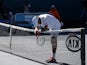 Frenchman Jeremy Chardy rests on the net following his straight-sets defeat to Andy Murray on January 23, 2013