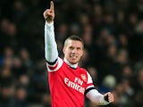 Lukas Podolski celebrates scoring the equaliser against West Ham on January 23, 2013