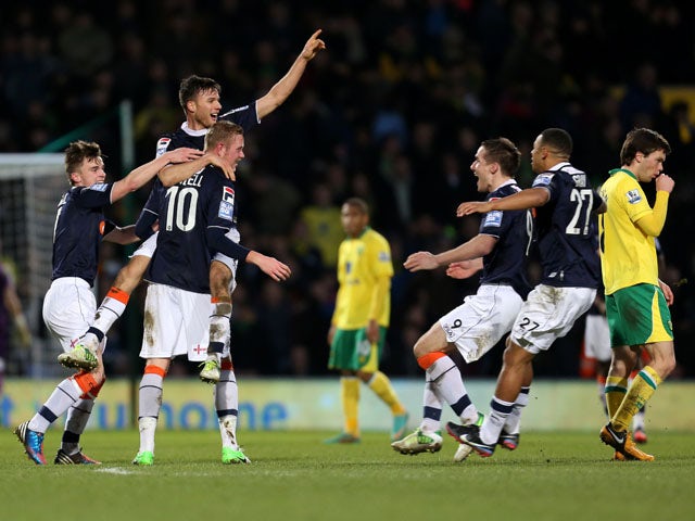 Luton player Scott Rendall celebrates with teammates after scoring his sides goal in their FA Cup fourth round match against Norwich on January 26, 2013