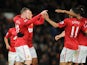 Manchester United forward Wayne Rooney celebrates with teammates after scoring his sides second goal in their FA Cup fourth round match with Fulham on January 26, 2013