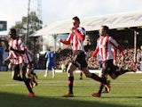 Brentford's Marcello Trotta celebrates with team mates after scoring the opening goal in the FA Cup fourth round tie with Chelsea on January 27, 2013