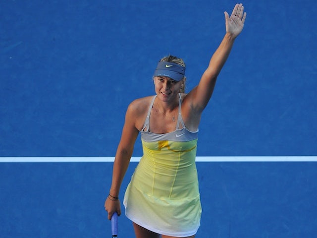Maria Sharapova waves to the crowd following her quarter-final victory over Ekaterina Makarova on January 22, 2013