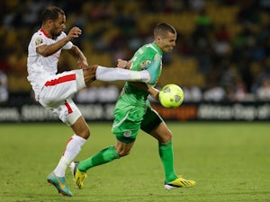 Tunisia's Saber Khalifa fights for the ball with Algeria's Djamel Mesbah during their ACON match on January 22, 2013