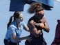 An injured Serena Williams receives treatment during her match with Sloane Stephens on January 23, 2013