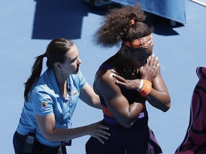 An injured Serena Williams receives treatment during her match with Sloane Stephens on January 23, 2013