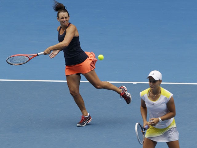 Caseu Dellacqua of Australia hits the ball past partner Ashleigh Barty during the women's doubles final at the Australian Open tennis championship on January 25, 2013