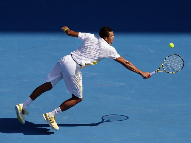 Frenchman Jo-Wilfried Tsonga stretches for a return shot during his fourth round match with Richard Gasquet at the Australian Open tennis championship on January 21, 2013