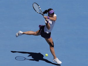 China's Li Na hits a backhand return in her semifinal match against Maria Sharapova at the Australian Open tennis championship on January 24, 2013