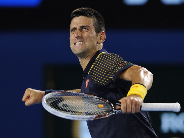 Novak Djokovic celebrates defeating David Ferrer at the Australian Open tennis championship on January 24, 2013