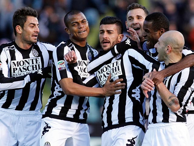 Siena's Alessio Sestu is congratulated by team mates after scoring his team's second against Inter on February 3, 2013