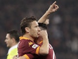 AS Roma forward Francesco Totti celebrates with a teammate after scoring in his sides match with Cagliari on February 1, 2013