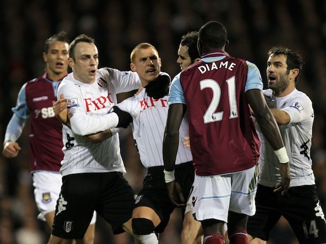 Fulham's Dimitar Berbatov clashes with West Ham midfielder Mo Diame on January 30, 2013