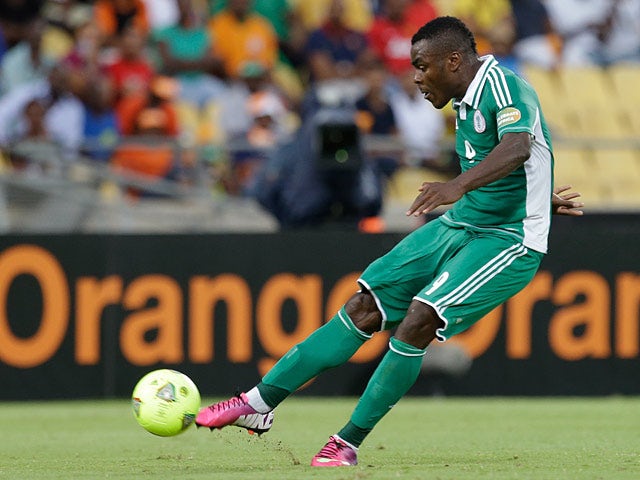 Nigeria's Emmanuel Emenike takes a free kick to score the opening goal of the match against Ivory Coast on February 3, 2013
