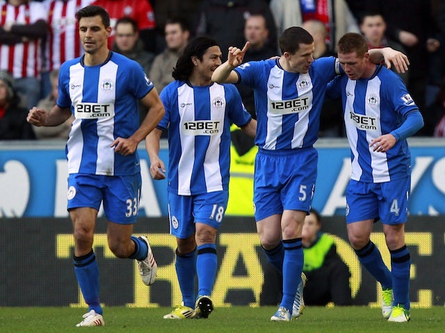 Wigan players congratulate Gary Caldwell after his opener against Southampton on February 2, 2013
