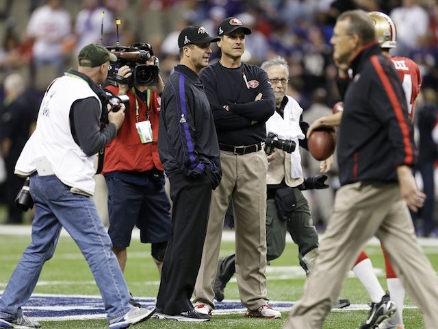 Brother and opposing coaches John & Jim Harbaugh on the field before Superbowl XLVII on February 3, 2013