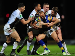 Leeds Rhinos' Jamie Jones-Buchanan is held by the Hull FC defence in the Super League match on February 1, 2013