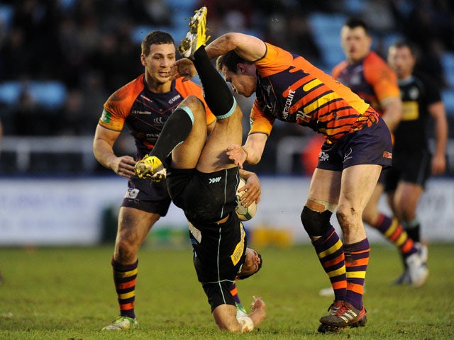London Broncos' Keiran Dixon tackled by Widnes Vikings' Joe Mellor during the side's match on February 3, 2013 