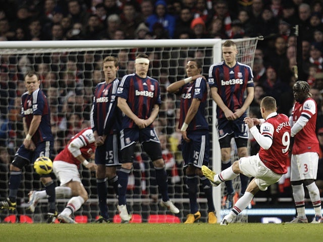 Lukas Podolski scores a deflected free-kick against Stoke on February 2, 2013