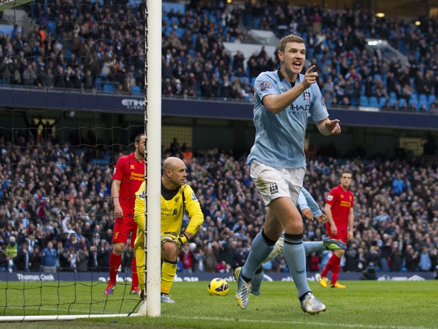 Manchester City forward Edin Dzeko celebrates after scoring against Liverpool on February 3, 2013