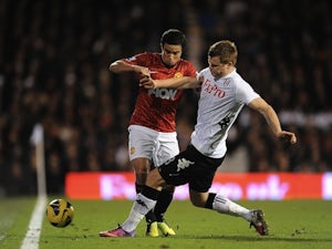 United right-back Rafael challenges John Arne Riise during the game with Fulham on February 2, 2013