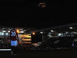 Robin Van Persie stands in the shadow of Craven Cottage after floodlight failure during the game between Fulham and Man Utd on February 2, 2013