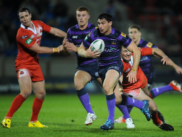 Wigan Warriors player Matty Smith skips away from a challenge in his team's match with Salford City Reds on February 1, 2013