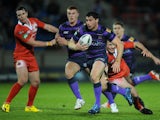 Wigan Warriors player Matty Smith skips away from a challenge in his team's match with Salford City Reds on February 1, 2013
