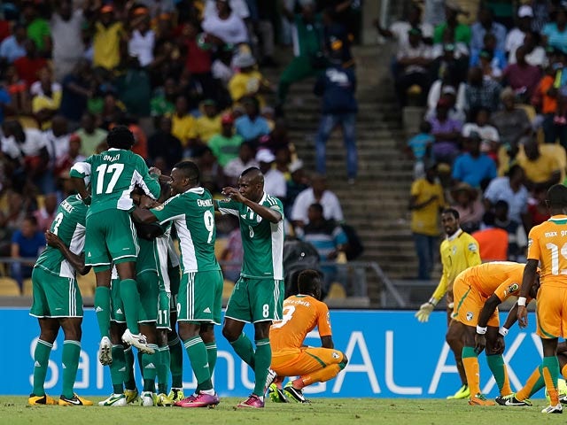 Sunday Mba is mobbed by his team mates after scoring the winner against Ivory Coast on February 3, 2013