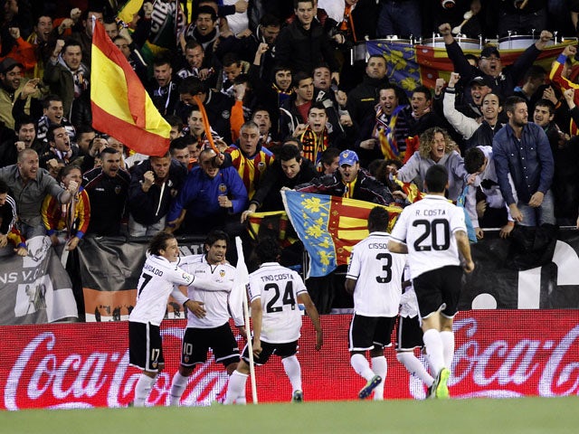 Valencia player Ever Banega celebrates with teammates after scoring against Barcelona on February 3, 2013