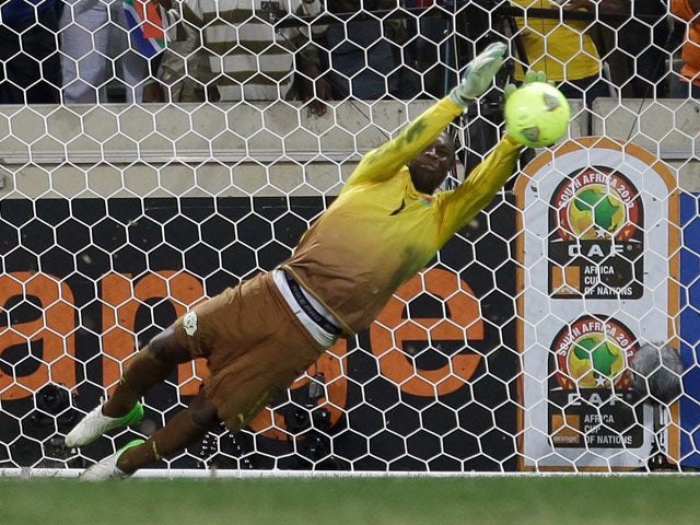 Burkina Faso goalkeeper Daouda Diakite saves a penalty kick to win the match for his team during their penalty shoot out victory over Ghana on February 6, 2013
