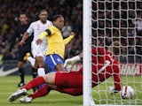 England's Joe Hart saves the ball after Brazil's Ronaldinho follows up his missed penalty in their side's match on February 6, 2013