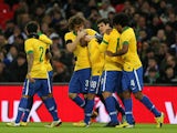 Teammates congratulate Brazil player Fred after scoring against England on February 6, 2013